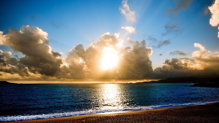 Sunset over the ocean with dramatic clouds