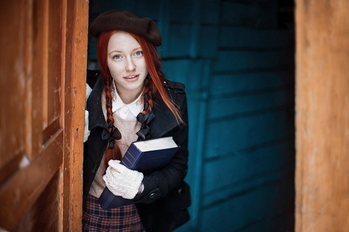 Redhead girl with book in doorway