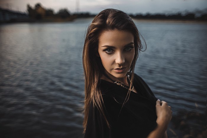 Woman with brown hair by the water