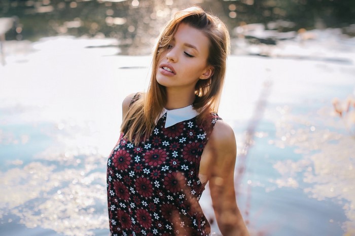 Woman with auburn hair in a floral dress