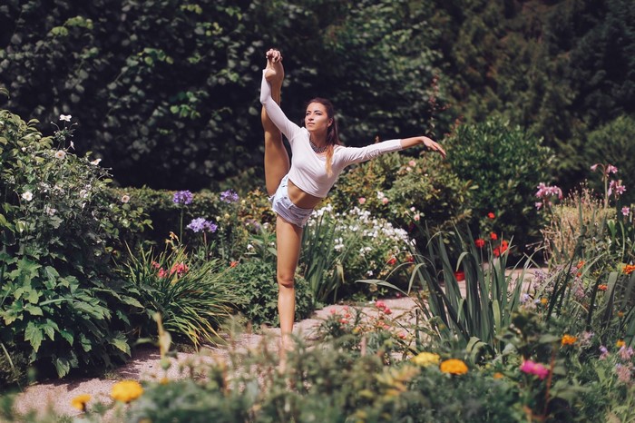 Woman Stretching in Blooming Garden