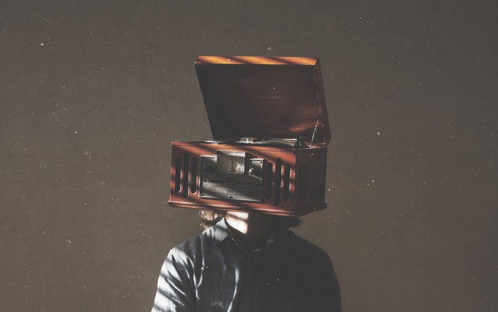 Person with a vintage record player on their head
