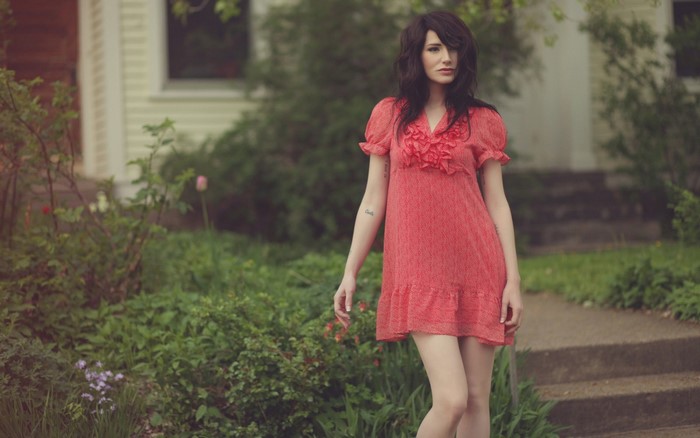 Woman in red dress standing outdoors
