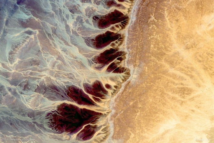 Aerial view of desert landscape with dry riverbeds
