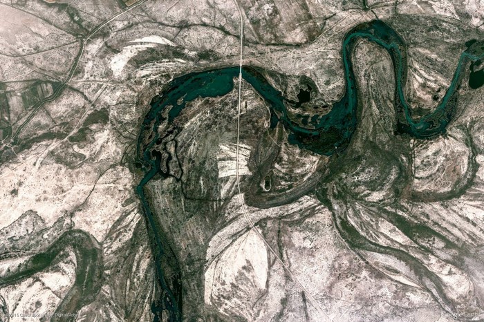 Aerial view of a winding river and arid landscape