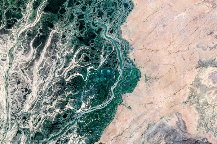 Aerial view of a river delta and desert landscape