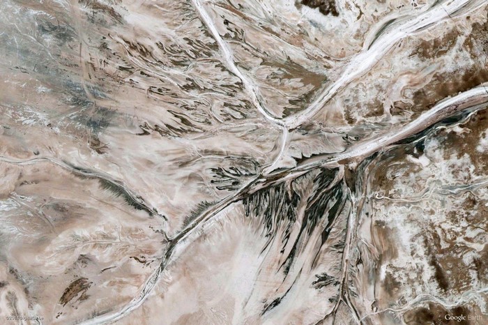 Aerial view of arid landscape with dry riverbeds