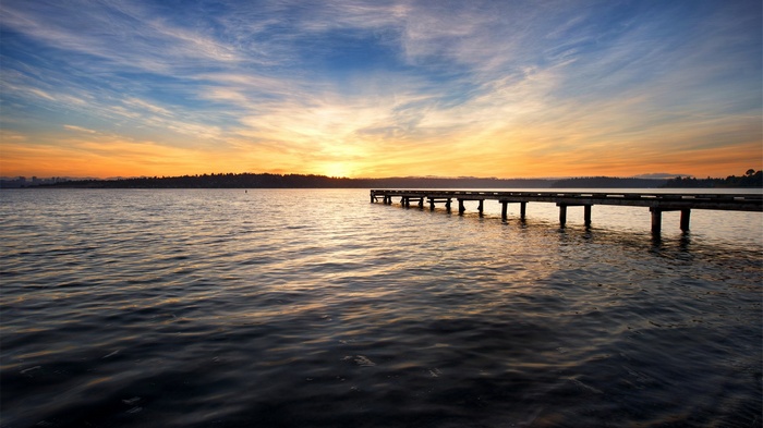 Wooden pier on a lake at sunset