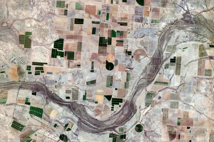 Aerial view of agricultural fields and a river