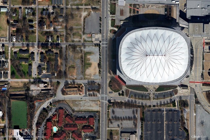 Aerial view of a stadium and surrounding urban area