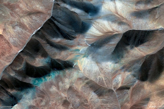 Aerial view of a mountainous landscape with blue water