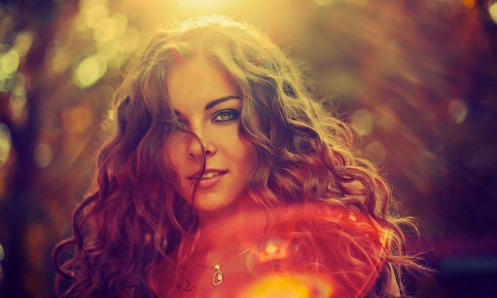 Woman with curly hair in sunlight