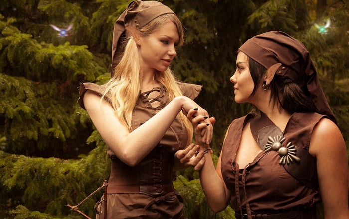 Two women dressed as elves in a forest