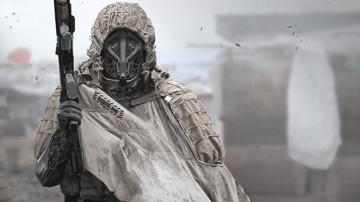 Futuristic soldier in camouflage holding a rifle