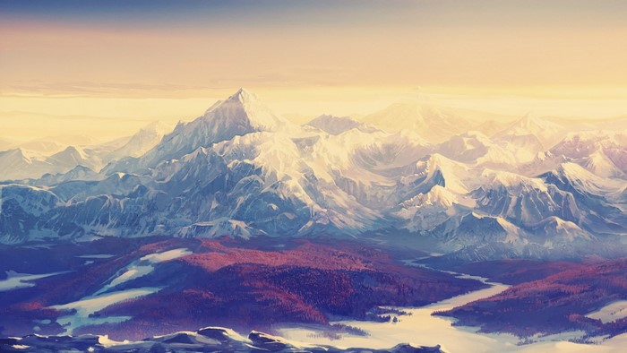 Snow-capped mountains at sunrise with a valley below