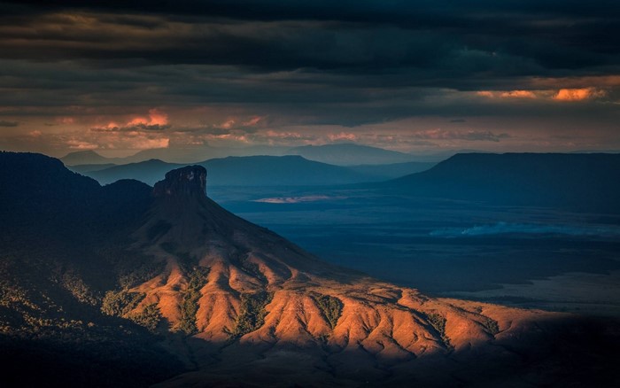 Tabletop mountain at sunset with dramatic clouds