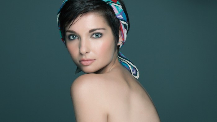 Woman with short dark hair and colorful headscarf