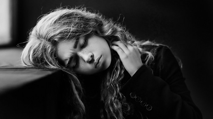 Monochrome portrait of a young woman with curly hair