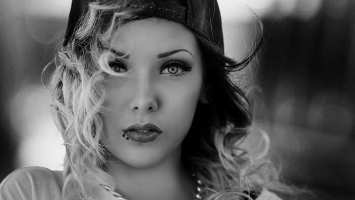 Monochrome portrait of a woman wearing a baseball cap