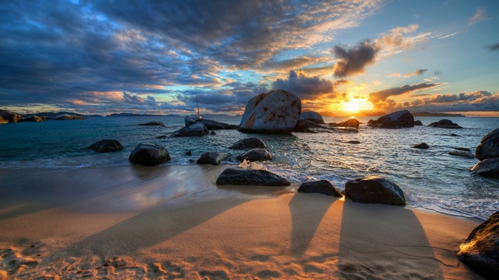 Sunset over rocky beach with ocean waves