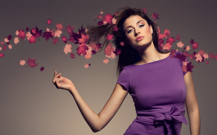 Woman in purple dress with falling leaves