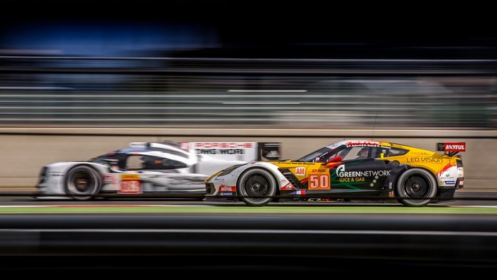Porsche and Corvette race cars on a track