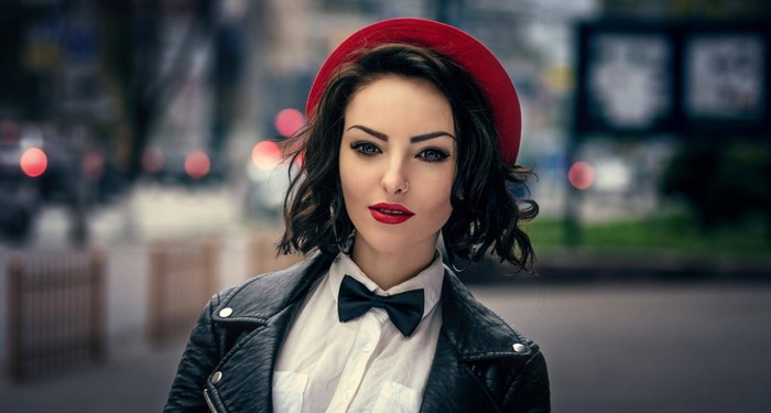 Woman wearing a red hat and leather jacket