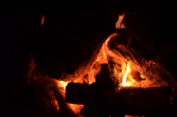 Burning logs in a dark campfire