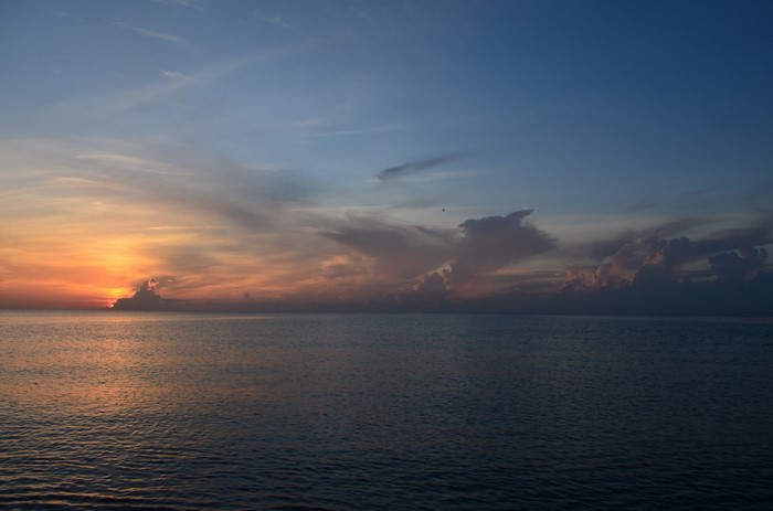 Sunset over the ocean with clouds