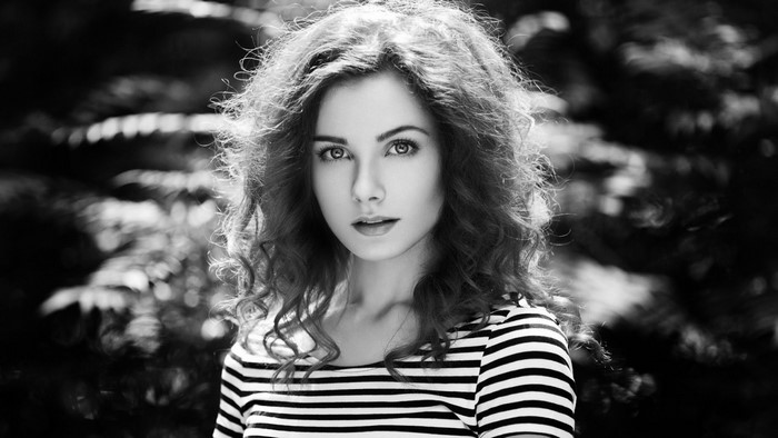 Black and white portrait of a woman with curly hair
