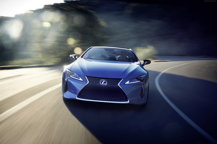 Blue Lexus LC 500h driving on a winding road