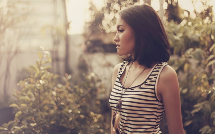 Woman in striped tank top with necklace