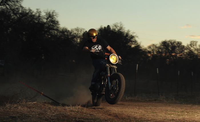 Man on a motorcycle doing a wheelie