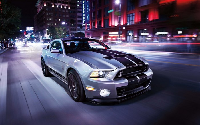 Silver Ford Mustang Shelby GT500 driving at night