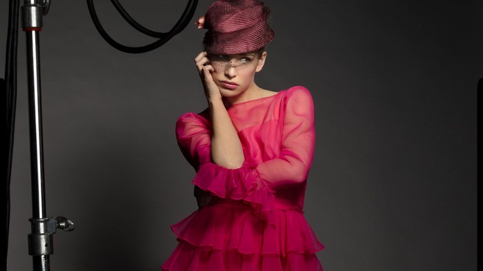 Model in pink dress and hat