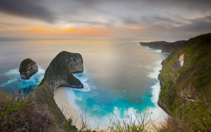 Coastal cliffs and rock formations at sunset over the ocean