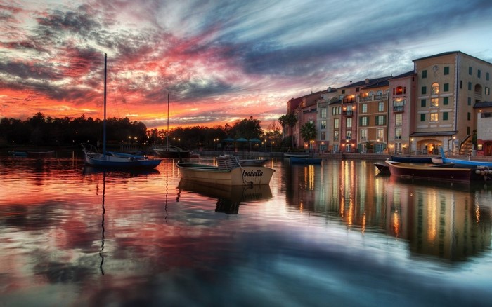 Boats on a canal at sunset with buildings