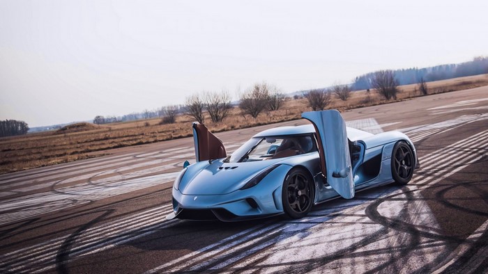 Light blue Koenigsegg Regera with doors open on a track