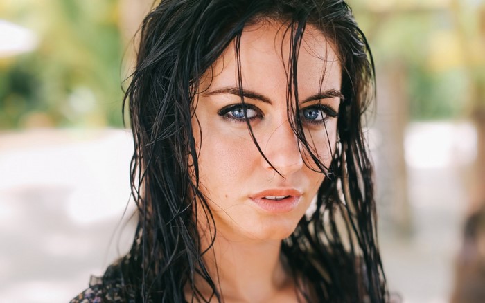 Woman with wet hair and blue eyes