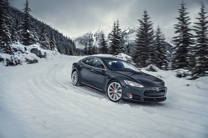 Tesla Model S P85D driving on a snowy mountain road