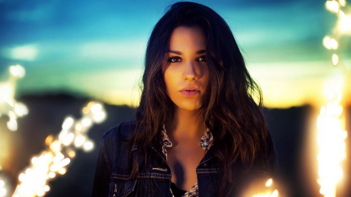 Woman in denim jacket with sparklers
