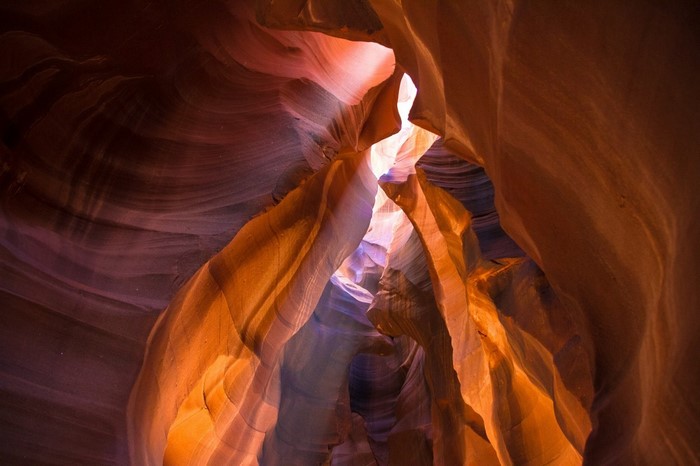Sunlight filtering through a sandstone canyon
