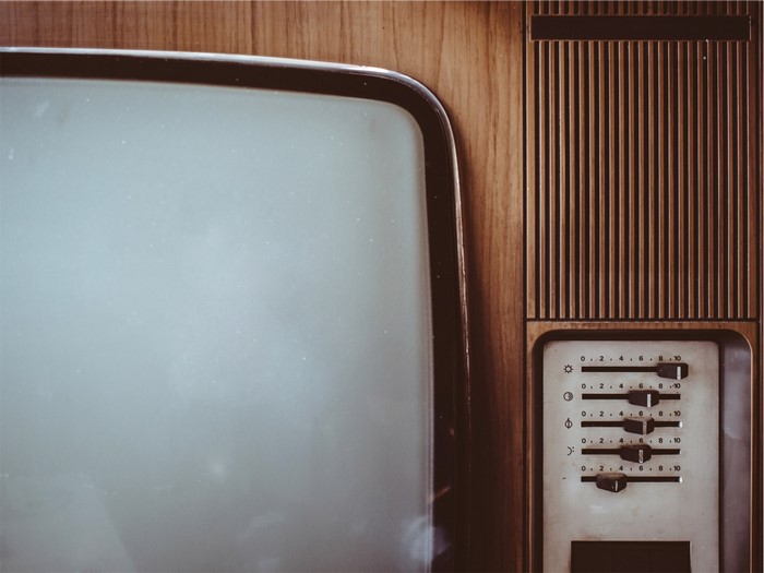 Close-up of a vintage television set with wooden casing