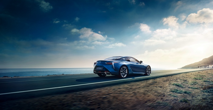 Blue Lexus LC 500h driving on coastal road
