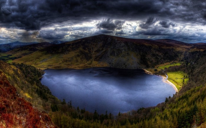 Dark clouds over a lake and mountains in Ireland