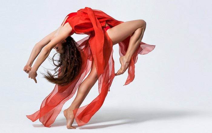 Graceful Modern Dance Pose in Flowing Red Dress