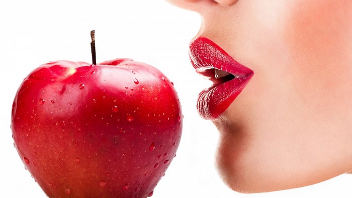Woman with red lipstick and red apple