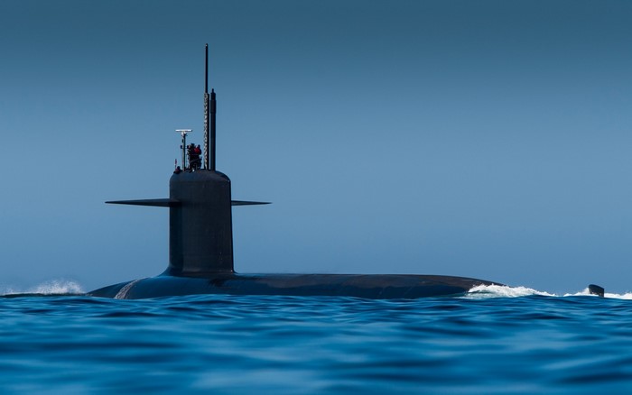 Submarine sailing on the ocean under a clear blue sky
