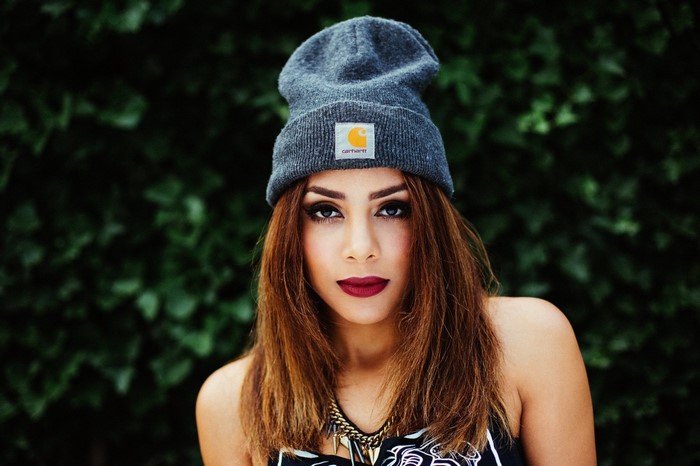Woman wearing a Carhartt beanie and necklace