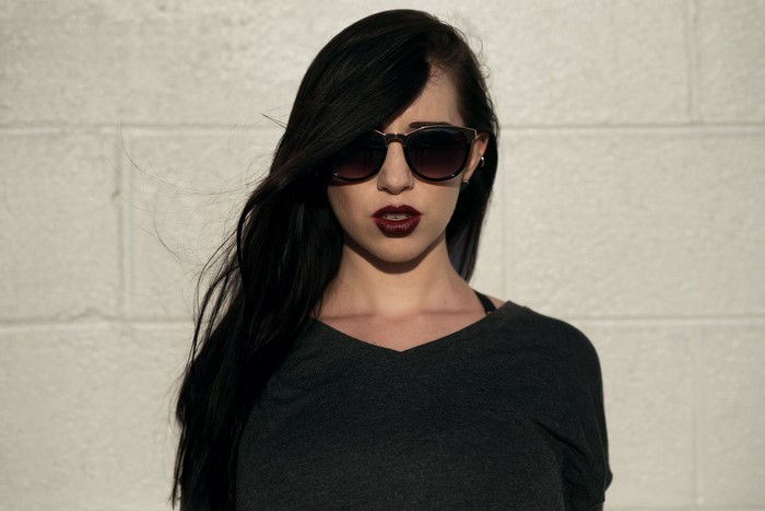 Woman with dark hair and sunglasses